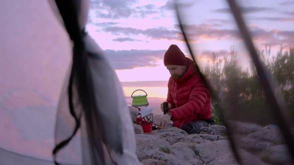 Man Makes Coffee When Camping at Sunset