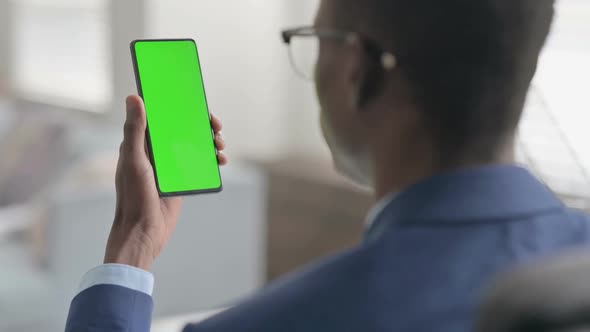 Young African Businessman Using Smartphone with Chroma Screen