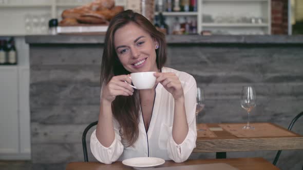 Smiling woman with cup