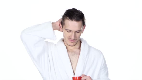 Sleepy Man Yawning, Scratching His Hair, Drinking Coffee. White. Close Up