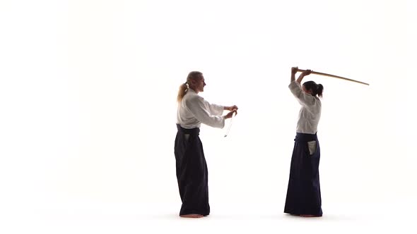 Man, Woman Demonstrating Aikido Using Bokken