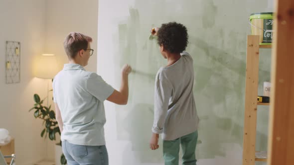 Multiethnic Mom and Child Painting Room Together