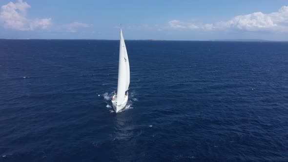 Yacht Sailing at Sunset During a Storm