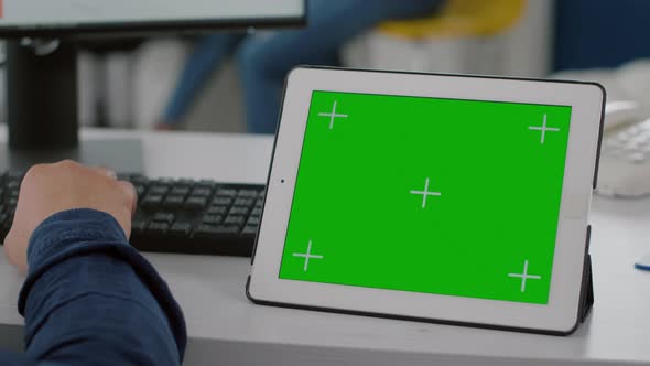 Close Up of Tablet with Chroma Key Display Project Manager Typing on Pc