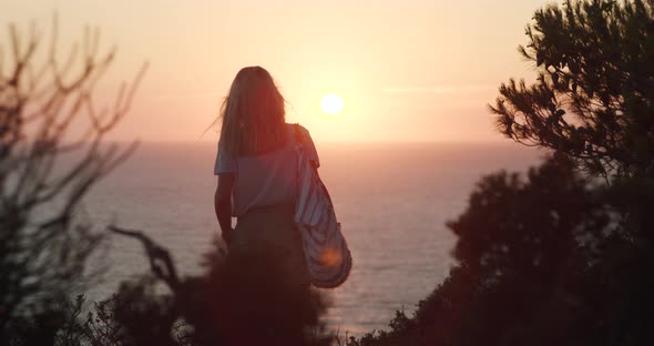 Woman Walk Towards Beautiful Glow Sunset Enjoying the Sea View