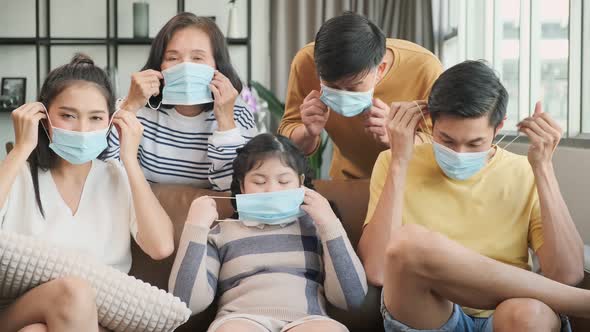 asian family multi generation wearing surgical facial mask together and stay home