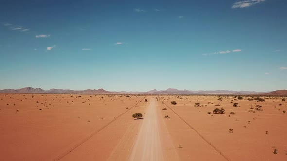 Namibian Gravel Road in Kalahari Desert in Africa. Aerial Drone Shot. Lanscape of the Road in the De