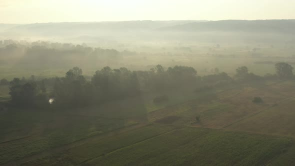 Early morning scenery with fog and sun light shadows 4K drone footage
