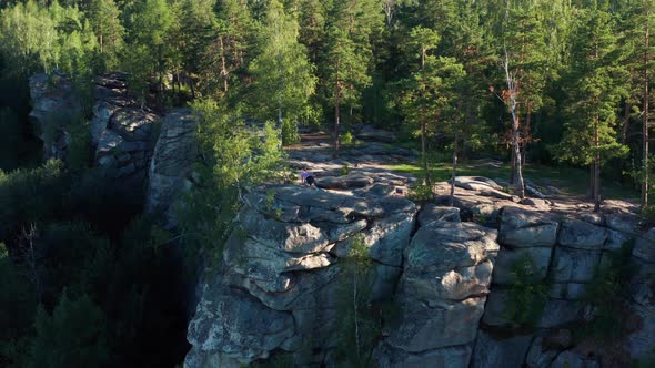 Aerial View of a Girl Doing Fitness and Yoga on the Edge of a Cliff