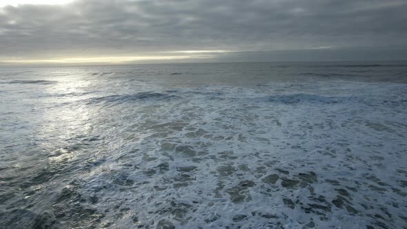 Ocean Waves Splash at Sunset Light