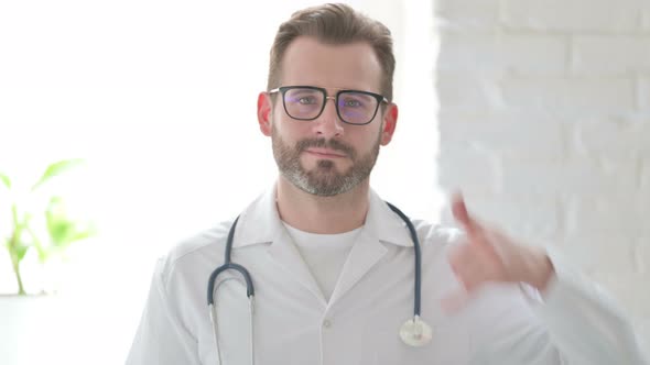 Portrait of Doctor Showing Call Me Sign