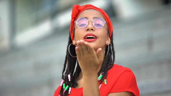 Friendly Stylish African-American Girl Sending Air Kisses to Camera, Good Mood