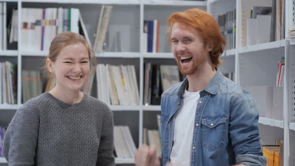 Young Man and Woman Reacting to Success