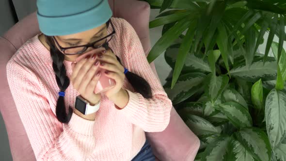 Mixed Race Hipster Woman Sitting in Cafe, Drinking Coffee and Using Smartphone