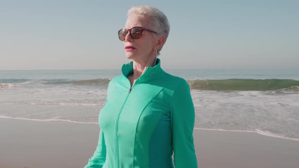 Senior Woman Exercising At The  Beach