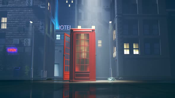 Red phone booth at foggy night. full of town lights. British touristic landmark