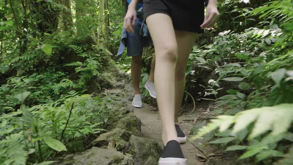 Couple’s Legs Hiking In The Forest Trail