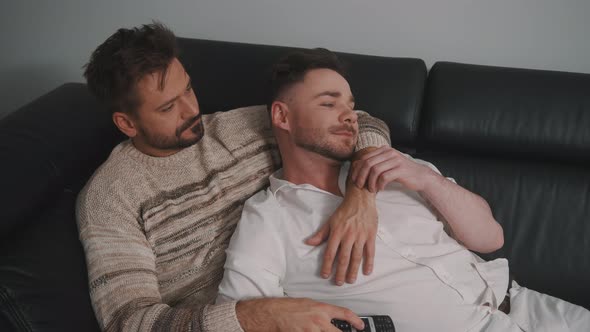 Young Guy Male Couple Cuddling on the Couch and Watching Tv