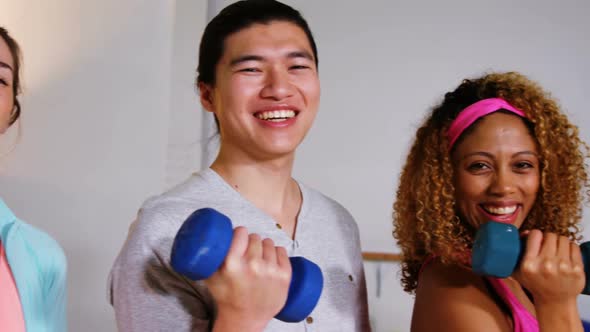 Group of fitness team holding dumbbell