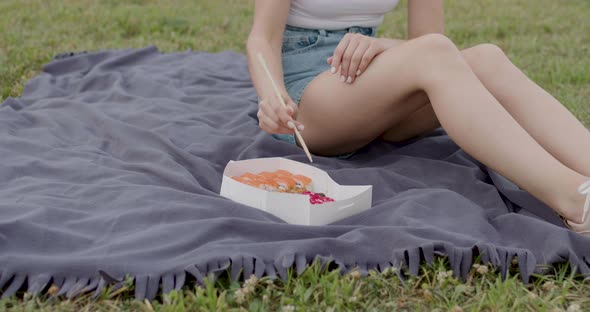 The Girl From Afar Eats Rolls and Sushi with Japanese Chopsticks