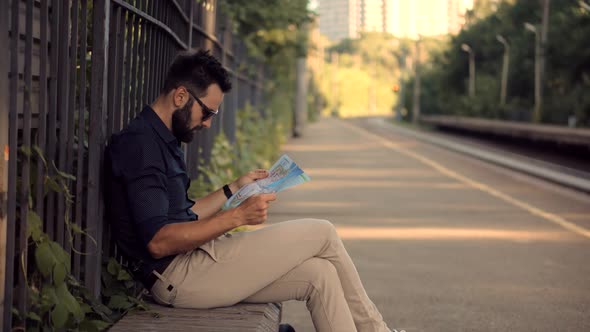 Businessman Tourist Looking On City Paper Map And Exploring City Route. Active Lifestyle On Vacation