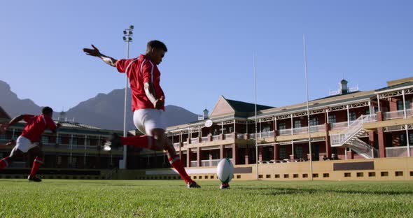 Rugby player kicking the ball from the kicking tee in the stadium 4k