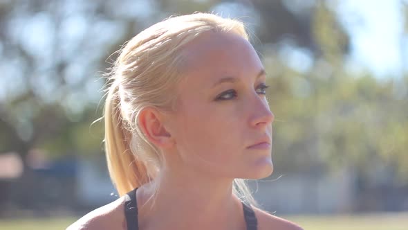 A young woman runner taking a break from her run.