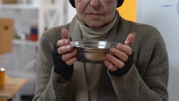 Poor Unhappy Homeless Woman Showing Empty Plate to Camera, Lack of Funding