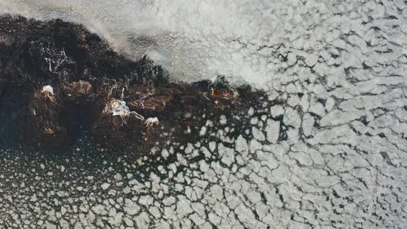 Stones in the Sea About Which the Sea with Ice Floes Splashes