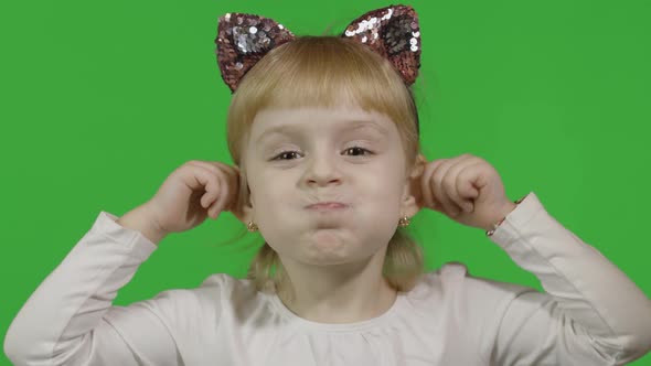 Girl in Cat Headband Touches Her Ears and Make Faces. Happy Four Years Old Child