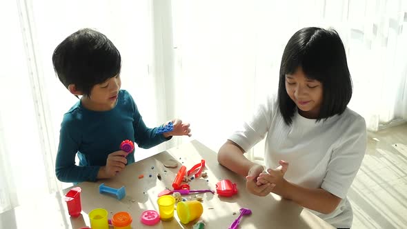 Asian Children Have A Fun Together With Colorful Modeling Clay At Home