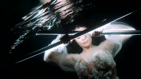 Underwater Princess is Floating in Dark Depth Holding Two Magical Glowing Wands Mysterious Portrait