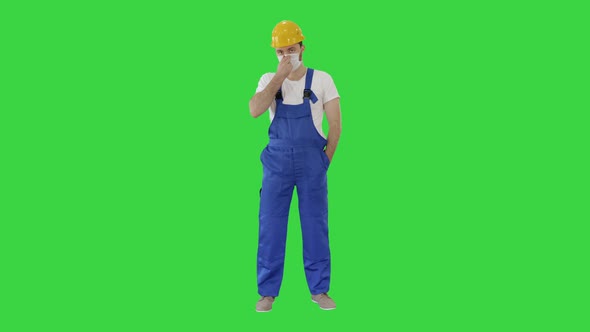 Masked Construction Man in Hardhat on a Green Screen, Chroma Key.