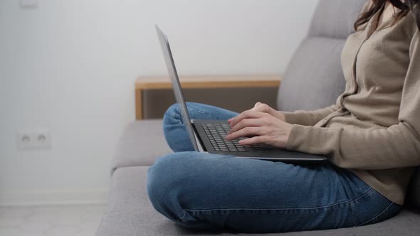 Freelancer girl working on computer on lockdown while sitting in living room