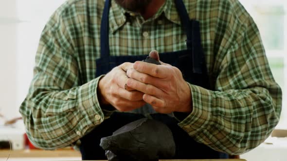 Craftsman working on clay sculpture