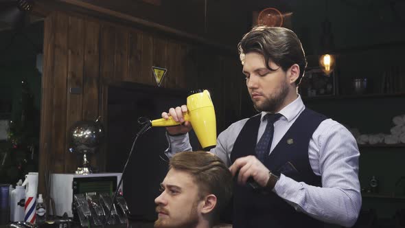 Handsome Bearded Professional Barber Working with His Client