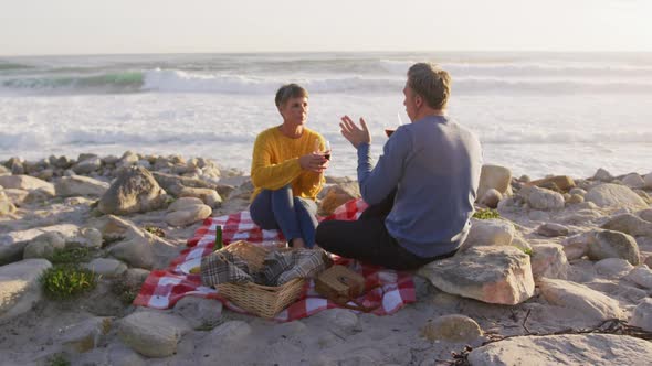 Couple drinking wine by the sea