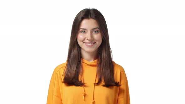 Slowmotion Attractive Cheerful Brunette Girl in Orange Hoodie Showing Okay Alright Gesture Satisfied