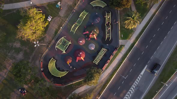 Kids have fun playing at modern playground in Buenos Aires in Argentina. Aerial drone overhead circl