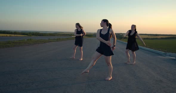 Young Women Spinning Doing Dancing Moves Outdoors in the Morning Film Grain