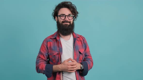 Portrait of Bearded Handsome Young Man That Is Smiling Over Turquoise Background