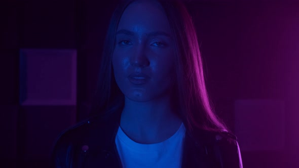 Fashion Portrait of Young Stylish Woman in Neon Light
