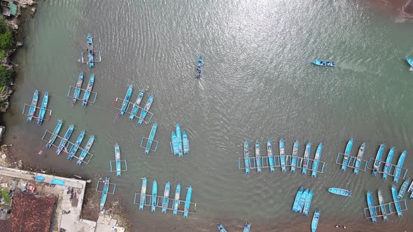 Top aerial view of traditional boats in lagoon beach in Indonesia