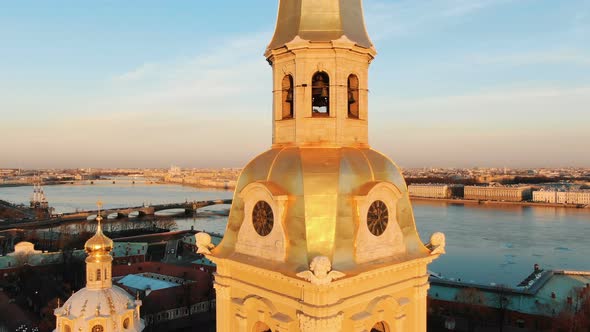 Aerial Fly of the Top of the Cathedral and the Bell Tower in the Peter and Paul Fortress at Sunset -
