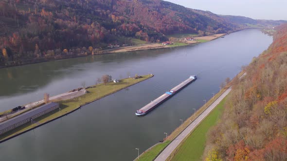 Cargo Pusher Boat on a River Transporting Cargo and Goods Along a Autumnal River