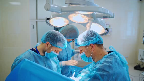 Group of neurosurgeons performing an operation