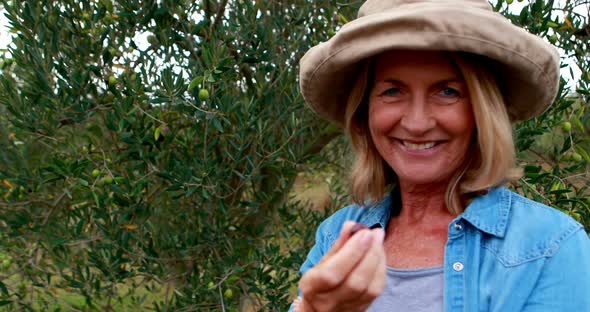 Portrait of happy woman holding olive 4k