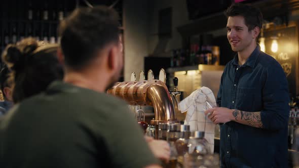 Caucasian male bartender working at bar. Shot with RED helium camera in 8K. 