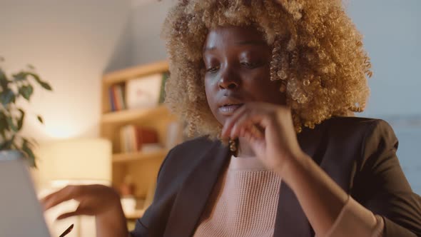 Stressed African American Businesswoman Overworking in Office