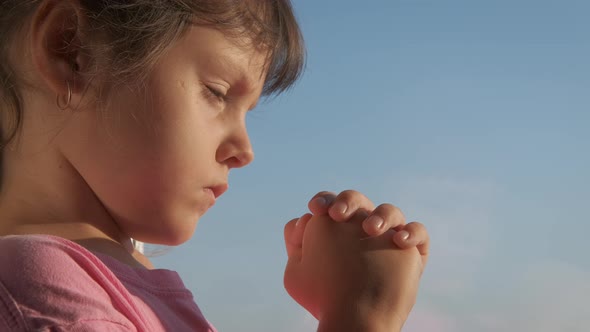 The child is praying. 